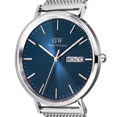 Close-up of the Classic Day Display Sterling Arctic watch showing the blue dial with a semi-transparent triangle pattern, silver hour markers, and a day and date window.