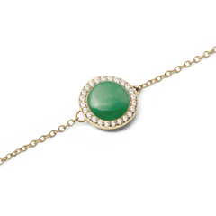 Close-up of the Audrey Bracelet Jade Gold, showcasing a domed green jade centrepiece encircled by sparkling cubic zirconia on a fine gold chain.