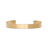 Line Cuff Brushed Gold features a minimalist open cuff design in brushed gold-tone stainless steel, with a smooth 7 mm wide band and a subtle matte finish.
