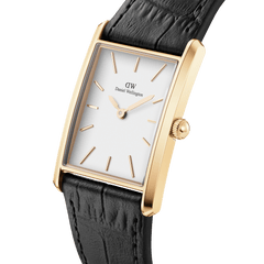 Daniel Wellington Bound Black Crocodile Gold watch featuring a rectangular gold case, minimalist white dial, and black crocodile-embossed leather strap, shown at an angle to highlight its slim profile and elegant detailing.