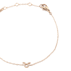 Close-up of the Crystal Zodiac Chain Bracelet Rose Gold, featuring a fine rose gold chain with adjustable sizing rings and a crystal-set Taurus zodiac pendant.