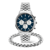 A silver Daniel Wellington chronograph men's watch with a blue dial and silver subdials is paired with a polished Ellipse Cuban Chain Bracelet, both featuring a matching stainless steel finish for a cohesive and modern look.