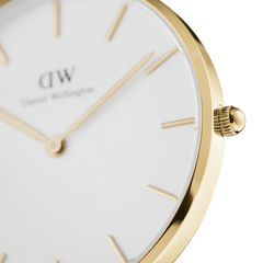Close-up of the Daniel Wellington Petite Evergold watch showing the gold-plated case, minimalist eggshell white dial, and slim gold hour markers for a refined, elegant finish.