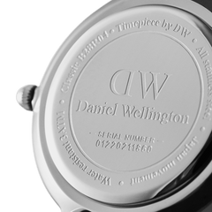 Close-up of the Petite Cornwall Silver watch case back, showing Daniel Wellington branding, engraved serial number, and stainless steel finish.