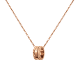 Rose gold Elevation Necklace with a geometric ring pendant featuring intricate detailing and a polished finish, suspended on a fine cable chain.