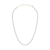 Classic Tennis Necklace Gold featuring a delicate gold chain with individually set sparkling crystals, shown with an adjustable clasp for versatile styling.