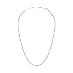 Classic Tennis Necklace Gold featuring a delicate gold chain with individually set sparkling crystals, shown with an adjustable clasp for versatile styling.