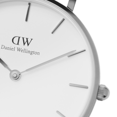 Detailed view of the Petite Sterling Silver watch face, highlighting the minimalist white dial, slim silver hands, and polished stainless steel case.