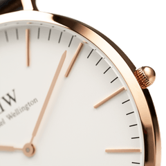 Close-up of the Classic St Mawes Rose Gold watch, highlighting the polished rose gold case, minimalist eggshell white dial, and slim rose gold hands and markers.