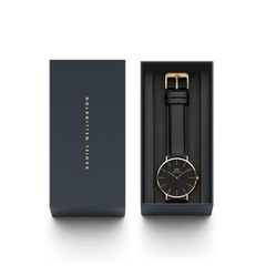 Classic Sheffield Gold watch with a black dial, gold-plated case, and black leather strap, elegantly presented in a Daniel Wellington gift box.