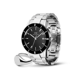 Silver stainless steel Daniel Wellington watch with a black dial and silver hour markers, paired with a polished silver signet ring featuring a sleek black face, both styled for men seeking modern elegance and versatility.