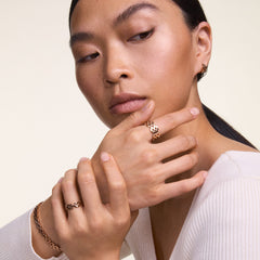 Woman wearing the 5-Link Ring Rose Gold, styled with matching rose gold bracelet and earrings, showcasing the ring's bold geometric links and polished finish in a modern, everyday look.