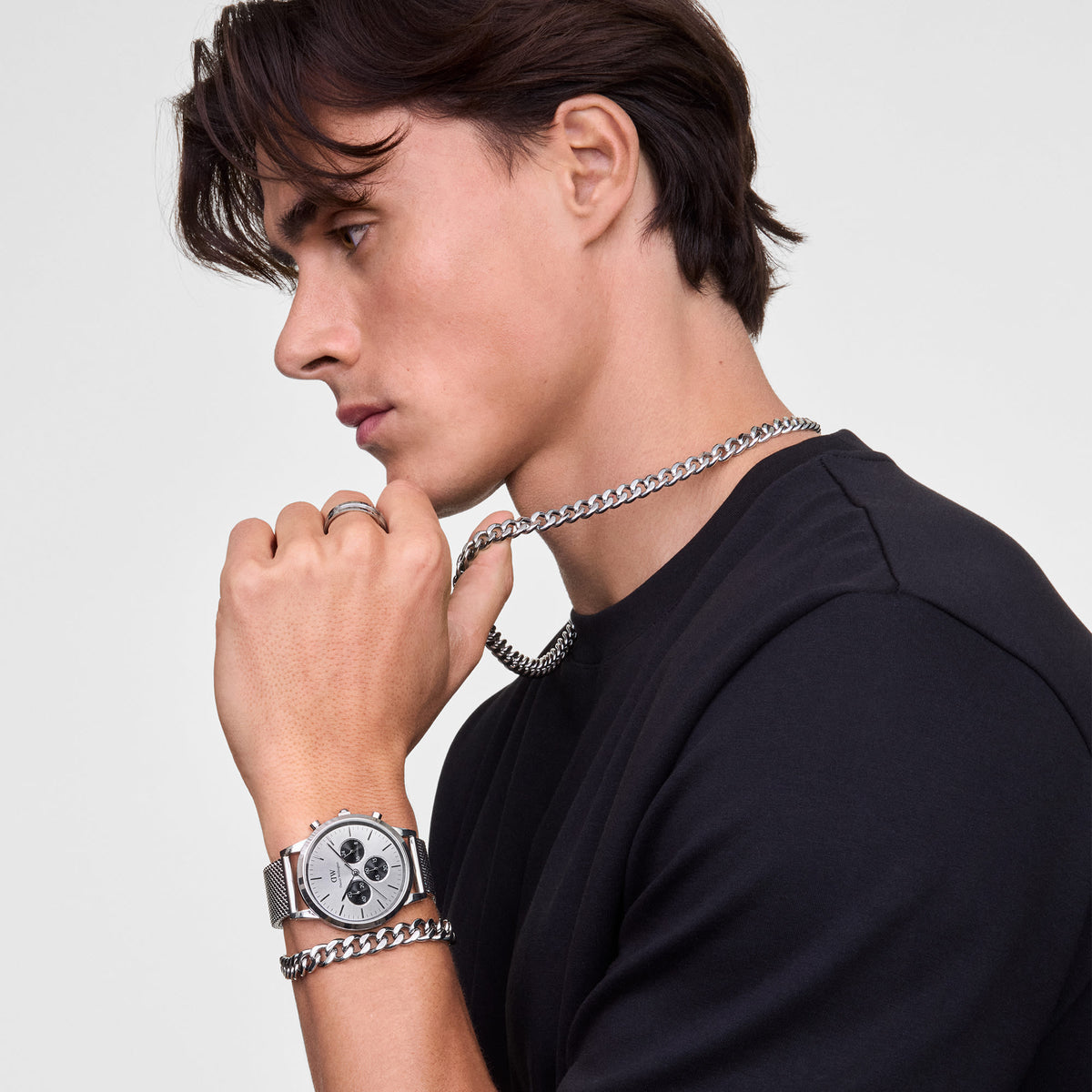 Ellipse Cuban Chain Bracelet Silver styled on a man's wrist alongside a silver watch and matching chain necklace, highlighting its chunky links and polished finish for a modern, sophisticated look.