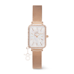 Rose gold ladies watch with a rectangular case, white mother of pearl dial, crystal border, and an interchangeable zodiac charm on an adjustable mesh strap.