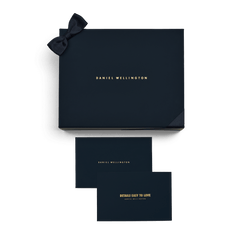Premium Gift Box Blue with a gold Daniel Wellington logo, fabric bow, and two matching cards for personalised messages, ideal for presenting jewellery, watches, or keepsakes.