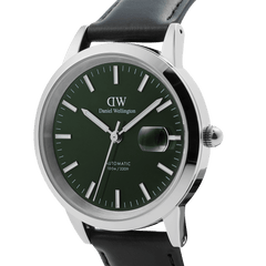 Close-up of the Iconic Sheffield Automatic Silver men's watch, featuring a polished silver case, emerald green enamel dial with luminous markers, magnified date window, and a black Italian leather strap.