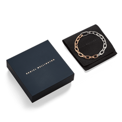 Contrast Link Bracelet Two Tone Rose Gold displayed on a black pouch next to a sleek Daniel Wellington gift box, highlighting the modern silver and rose gold chain design ideal for gifting or adding to your jewellery collection.