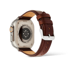 Rear view of an Apple Watch Ultra fitted with the Smartwatch Leather Strap St Mawes Silver, highlighting the brown genuine leather, polished silver pin buckle, and stitched padded design for a comfortable and stylish fit.
