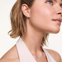 Crystal Hoop Earring Silver worn on the ear, showcasing its petite hoop shape and sparkling cubic zirconia detailing, styled with a minimalist stud and a delicate silver necklace for a polished, elegant look.