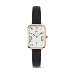 Quadro Roman Numerals Date Sheffield Rose Gold ladies watch with a rectangular rose gold case, white dial featuring bold Roman numerals, blue hands, date window at six o’clock, and a slim black leather strap.