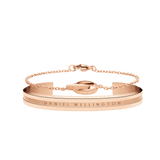 Rose gold bracelet set featuring a sleek cuff with engraved branding and a delicate chain bracelet with interlocking rings, both designed for a minimalist and elegant look.