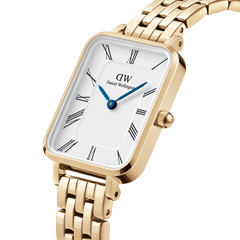 Quadro Roman Numerals 5-Link Gold watch with a rectangular white dial, Roman numerals, blue steel hands, and a polished gold 5-link bracelet, shown in a close-up angle highlighting its elegant details.