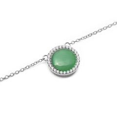 Close-up of the Audrey Necklace Jade Silver pendant, showcasing a polished green jade stone surrounded by a circle of sparkling white cubic zirconia crystals on a fine silver chain.