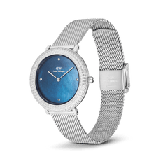 Crystalline Bezel Sterling Blue ladies watch by Daniel Wellington featuring a blue mother of pearl dial, crystal-set bezel, and an adjustable silver stainless steel mesh strap.