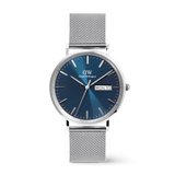 Classic Day Display Sterling Arctic men's watch featuring a blue dial with a semi-transparent triangle pattern, day and date window, and a stainless steel mesh strap with a safety buckle.