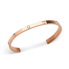Classic Lumine Bracelet Rose Gold 55mm shown at an angle, highlighting its polished rose gold finish and eight sparkling cubic zirconia crystals set along the slim, open cuff design.