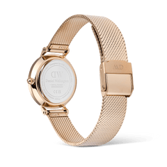 Daniel Wellington Petite Reflection Rose Gold watch showing the stainless steel case back, engraved details, and adjustable rose gold mesh strap with a secure clasp.