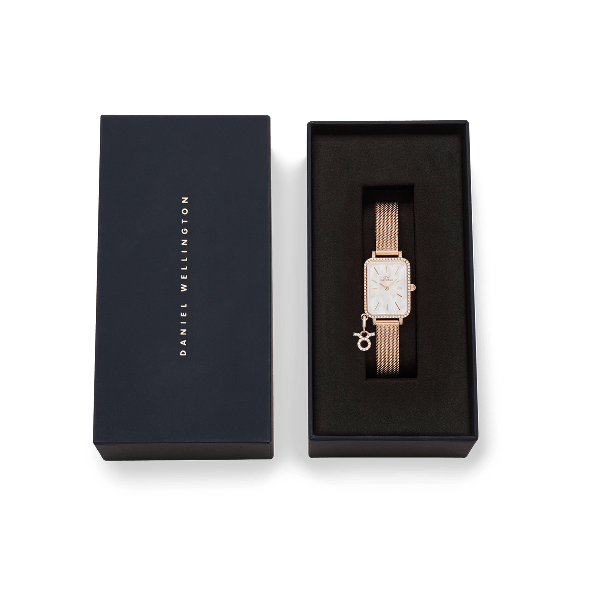 Quadro Crystal Zodiac Melrose Set presented in a sleek Daniel Wellington gift box, featuring a rose gold rectangular watch with a crystal-framed bezel, white mother of pearl dial, mesh strap, and a sparkling zodiac charm.