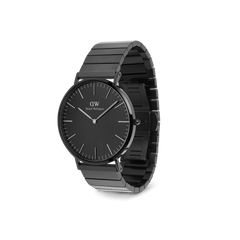 Classic Piano Link Onyx Unitone Black watch by Daniel Wellington displayed at an angle, featuring a brushed black dial, minimalist markers, and a geometric stainless steel piano link bracelet.