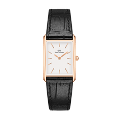 Rectangular rose gold watch with a minimalist white dial and black crocodile-embossed leather strap, featuring slim rose gold hour markers and a secure pin buckle.