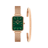 Rose gold ladies watch with a rectangular green dial and pressed mesh strap, paired with a slim rose gold bracelet engraved with Daniel Wellington branding, shown as a coordinated accessory set.