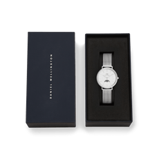 Petite Lune Sterling ladies watch with a silver mesh strap and minimalist white dial, presented in a Daniel Wellington branded gift box, ideal for gifting or special occasions.