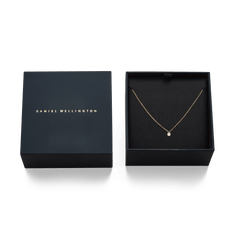 Mirelle Solitaire Necklace Gold displayed in an elegant black Daniel Wellington gift box, highlighting the fine gold chain and single cubic zirconia pendant as a ready-to-gift jewellery piece.