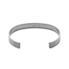 Line Cuff Brushed Silver featuring a slim open cuff shape, brushed stainless steel finish, and discreet inner logo, designed for a comfortable and minimalist look.