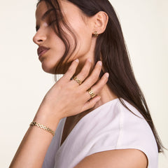 Woman wearing the 5-Link Ring Gold on two fingers, styled with matching gold bracelet and earrings, showcasing the bold, geometric link design and polished finish of the jewellery set.