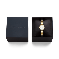 Petite Mini Arch 3-link White Gold watch presented in a sleek Daniel Wellington gift box, showing the elegant gold bracelet and crisp white dial for a refined gifting experience.
