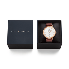 Classic Multi-Eye St Mawes Off-white Sunray Rose Gold men's watch presented in a black Daniel Wellington gift box, featuring a rose gold case, off-white textured dial, and brown leather strap.