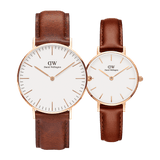 Classic & Petite St Mawes Rose Gold set featuring two Daniel Wellington ladies watches with warm brown leather straps, rose gold cases, and minimalist white dials, shown side by side to highlight the difference in case sizes.