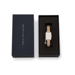 Quadro Crystal Zodiac Evergold Set gold ladies watch by Daniel Wellington with crystal-set bezel, white mother of pearl dial, gold mesh strap, and removable zodiac charm, presented in a premium branded gift box.