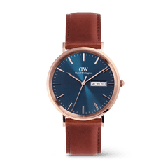 Classic men's watch with a blue textured dial, rose gold stainless steel case, and brown leather strap, featuring a day and date display for everyday practicality.