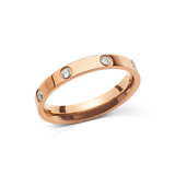 Classic Lumine Ring Rose Gold 4mm featuring a polished rose gold band with cubic zirconia crystals set evenly around the ring, showcasing its minimalist and elegant design.