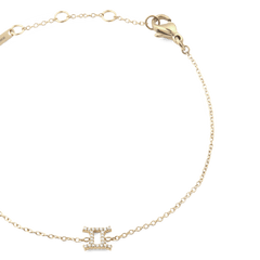 Close-up of the Crystal Zodiac Chain Bracelet Gold with a fine gold chain, adjustable sizing rings, and a crystal-encrusted Gemini zodiac charm at the centre.
