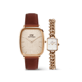 The Marlon & Jolie Chain Rose Gold Set features a men’s Daniel Wellington watch with a cushion-shaped rose gold case, textured warm white dial, and brown leather strap, paired with a women’s petite rectangular watch with a rose gold chain bracelet and crisp white dial.