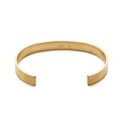 Line Cuff Brushed Gold shown from above, highlighting its open cuff shape, brushed gold finish, and smooth contoured edges for a comfortable fit.
