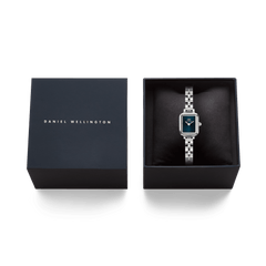 Quadro Mini Arch 3-link Arctic Sunray Silver ladies watch with a rectangular case and blue dial, presented in a black Daniel Wellington gift box.