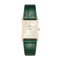 Rectangular gold women’s watch with a champagne sunray dial and a green crocodile-pattern leather strap, featuring minimalist gold hour markers and a slim profile suitable for everyday wear.